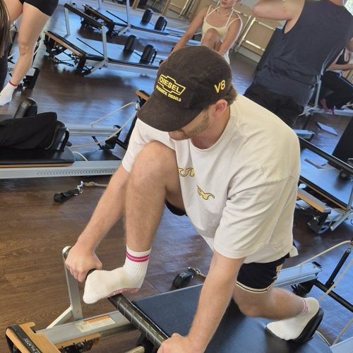 Man doing reformer Pilates exercises